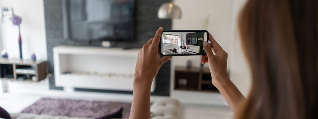 Woman taking photos of her home contents for insurance purposes