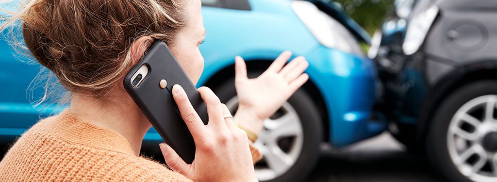 Female Motorist Involved In Car Accident Calling Insurance Company Or Recovery Service